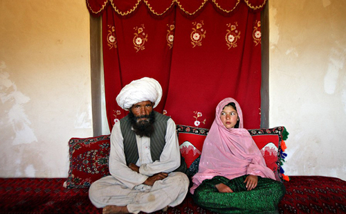 Faiz, 40 (left), and Ghulam (right), 11, sit in her home prior to their wedding in the rural Damarda Village, Afghanistan on September 11, 2005 Faiz, 40 (left), and Ghulam (right), 11, sit in her home prior to their wedding in the rural Damarda Village, Afghanistan on September 11, 2005