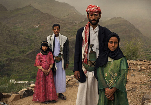 Tahani (front), 8, is seen with her husband Majed, 27, and her former classmate Ghada (rear), 8, and her husband outside their home in Hajjah, Yemen Tahani (front), 8, is seen with her husband Majed, 27, and her former classmate Ghada (rear), 8, and her husband outside their home in Hajjah, Yemen