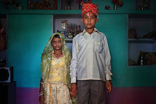 Maya, 8, and Kishore, 13, pose for a wedding photo inside their new home the day after the Hindu holy day of Akshaya Tritiya, or Akha Teej, in Rajasthan, India Maya, 8, and Kishore, 13, pose for a wedding photo inside their new home the day after the Hindu holy day of Akshaya Tritiya, or Akha Teej, in Rajasthan, India