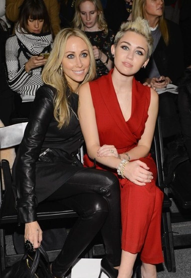 Miley Cyrus and her mother hit New York's shows in striking black leather and red ensembles.