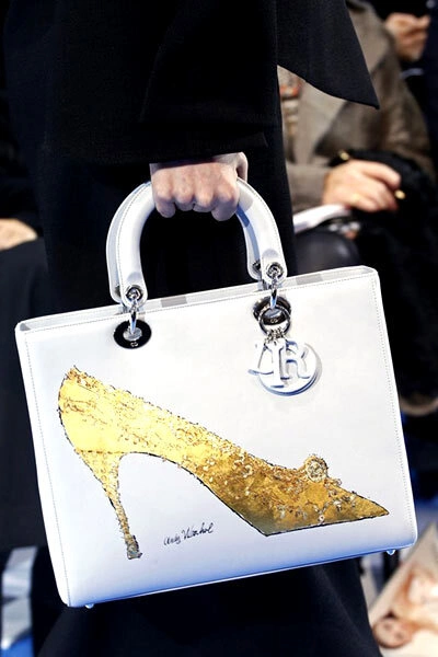 Performed in the brands signature shape, this bag from Christian Dior is a result of collaboration between the Artists Foundation for the Visual Arts and the legendary fashion brand. Performed in the brands signature shape, this bag from Christian Dior is a result of collaboration between the Artists Foundation for the Visual Arts and the legendary fashion brand.