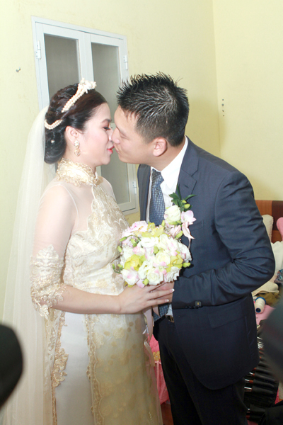 Khi được bước vào đón cô dâu Mỹ Dung xuống chào gia đình hai bên, chú rể Ngọc Tiến không quên dành tặng vị hôn thê của mình nụ hôn âu yếm. Khi được bước vào đón cô dâu Mỹ Dung xuống chào gia đình hai bên, chú rể Ngọc Tiến không quên dành tặng vị hôn thê của mình nụ hôn âu yếm.