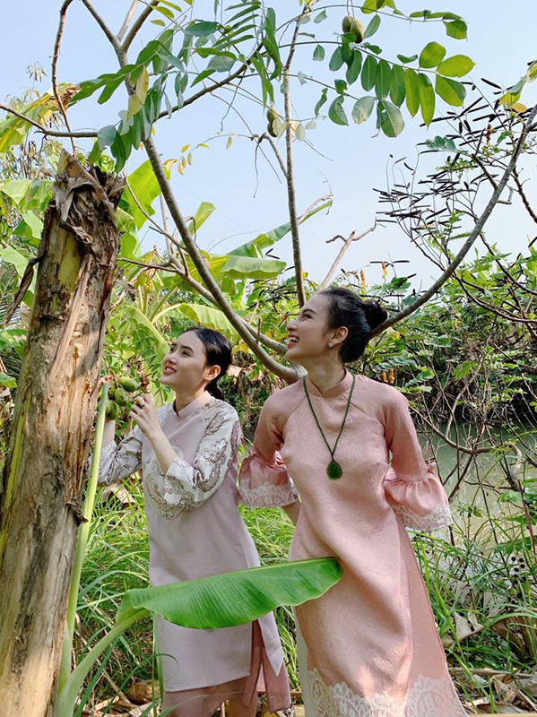 Ngọc Trang, em gái ruột của cô cũng thích thú ra khám phá vườn nhà nội. Cả hai mặc áo dài ton sur ton.